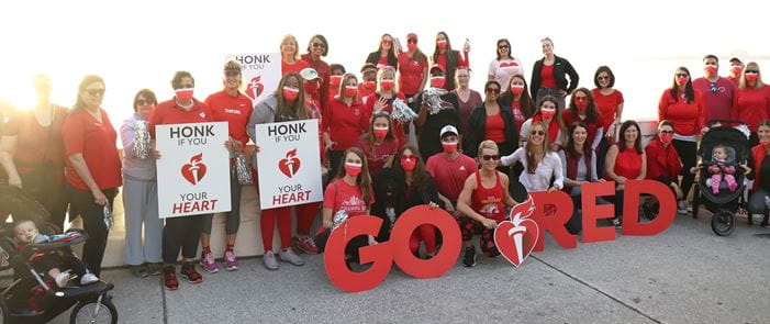 Raymond James associates and Tampa Bay community members wear red and hold